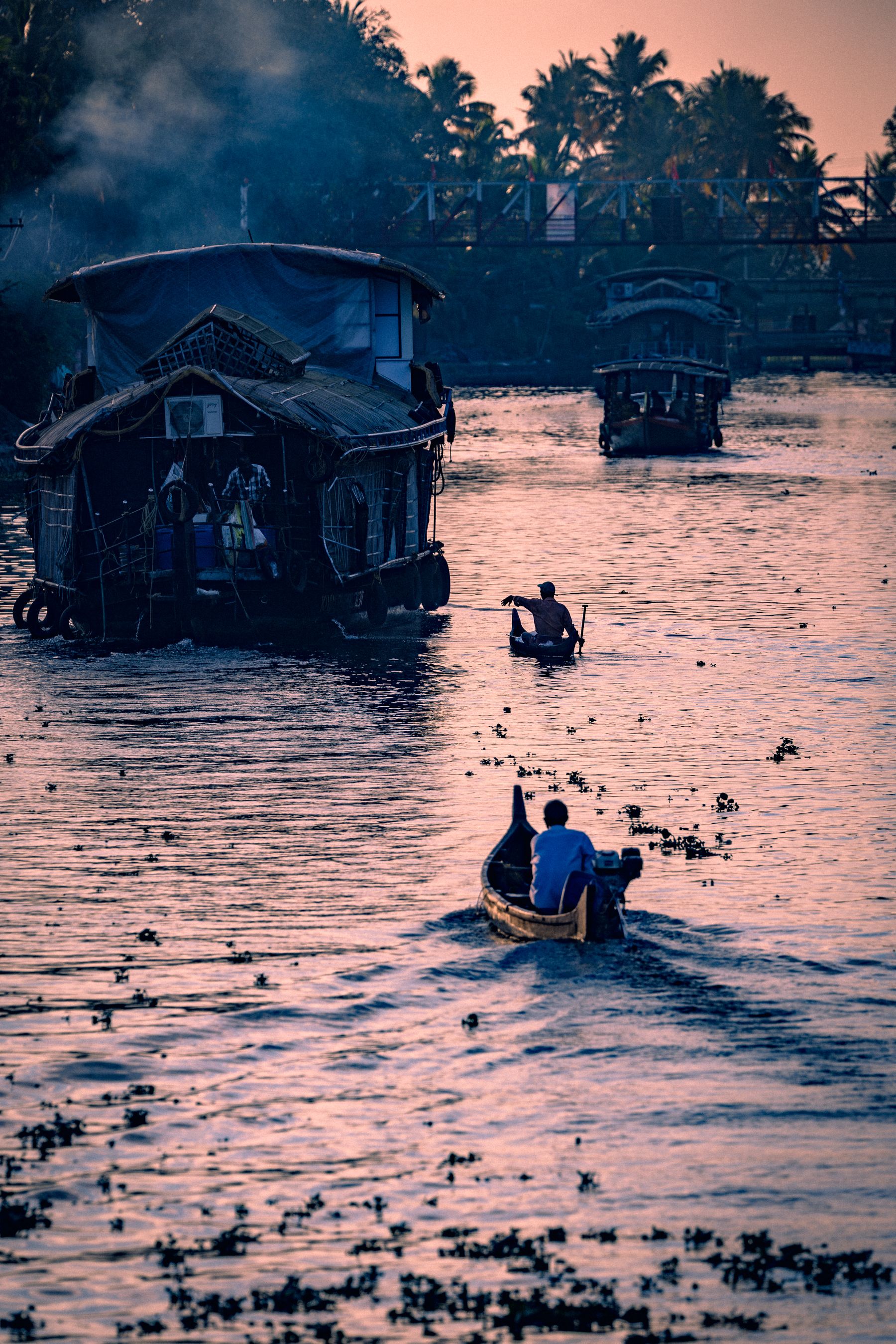 Canoe And People On Backwaters At Dusk